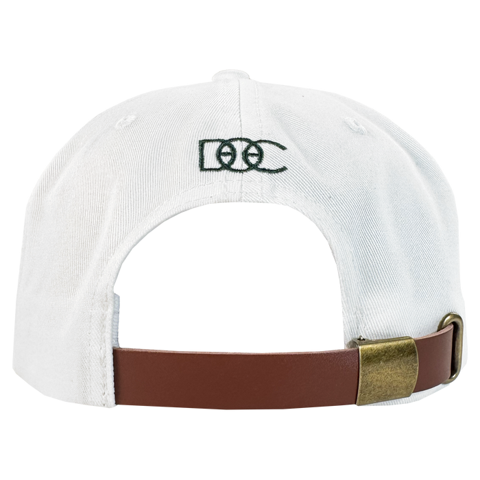 The Bay Area 5 Panel by DOC from Oaklandish features a white strap back, a brown adjustable strap with brass buckle, and green "DCC" embroidery above the opening on the plain white back.