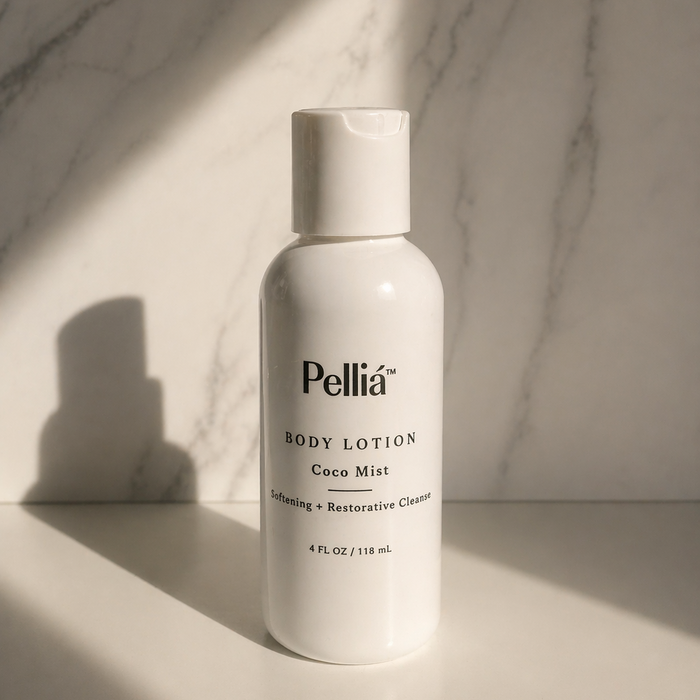 Pellia body lotion mini travel bottle on a marble surface with soft lighting