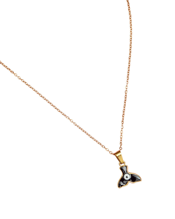 Evil eye necklace with gold chain and fin-shaped pendant, black and white enamel