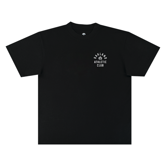 The OAC Prestigious Tee is a black, short-sleeve classic fit t-shirt featuring โOAKLAND ATHLETIC CLUBโ printed in a curved and stacked white font on the left chest, with a small graphic above the text. Made from heavy-weight cotton, it is photographed against a plain white background.