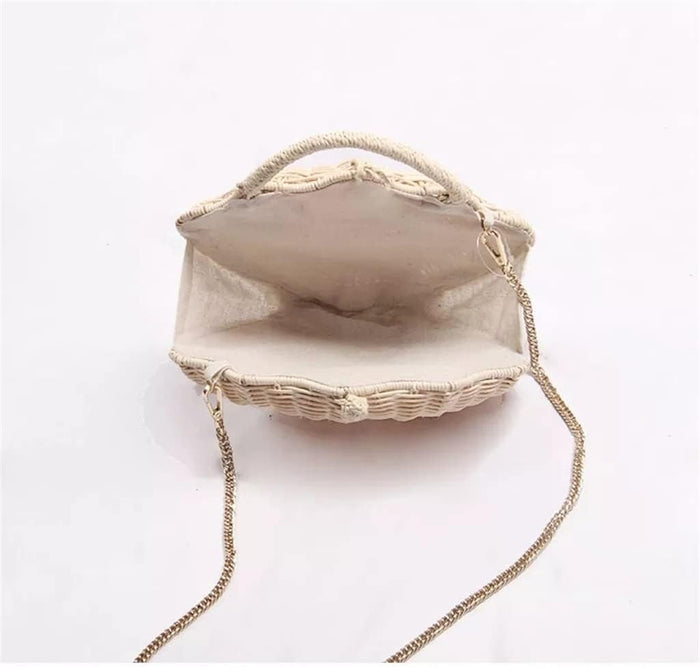 Grace Beauty shell-shaped raffia clutch handbag with woven design, crossbody strap, and pearl accents.