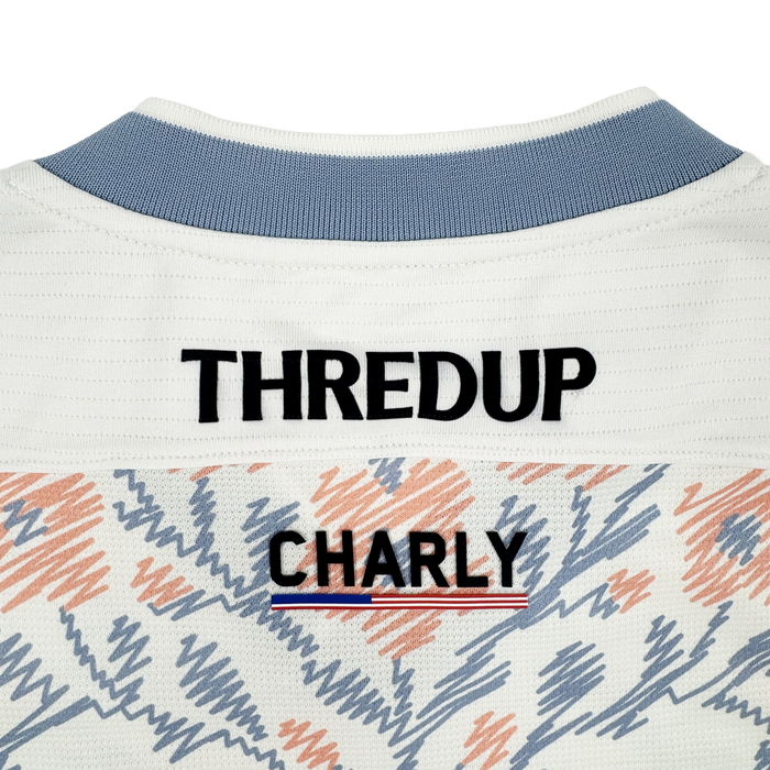 Close-up of the upper back of a white Oakland Soul 2026 SC Form Jersey, crafted from high-quality polyester. "THREDUP" is in bold black above "OAKLAND SOUL," with a red, white, and blue stripe and abstract orange and blue accents.