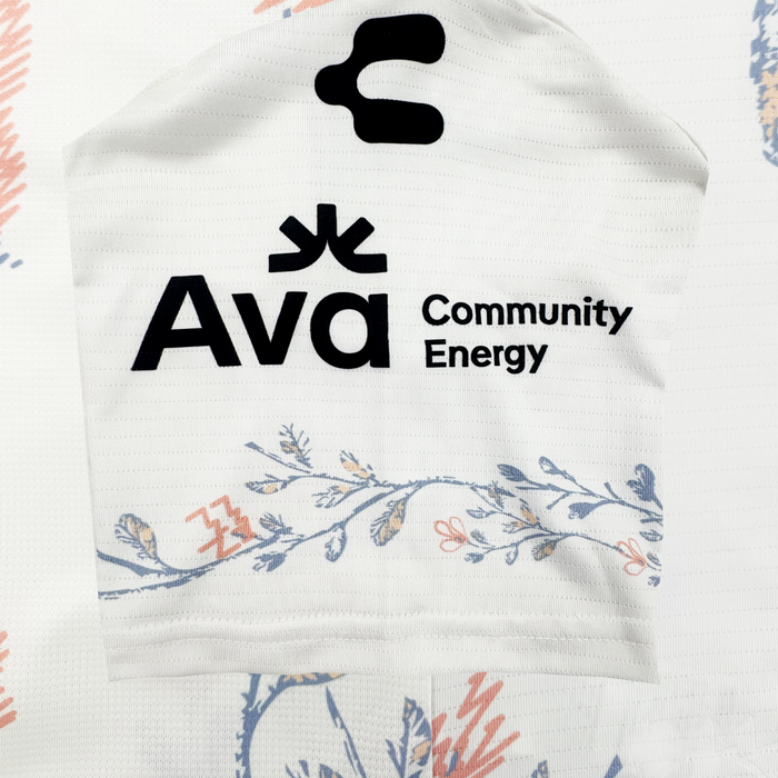 The 2026 Oakland Soul SC Form Jersey features “Ava Community Energy” in black text with a bold abstract logo above. Delicate blue and peach botanicals accent the bottom, highlighting the clean, modern Oakland Soul brand design.