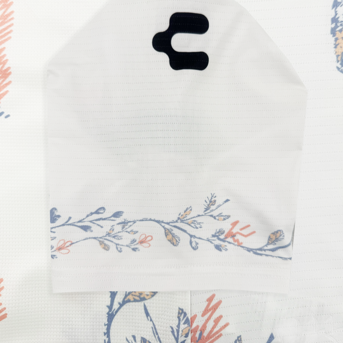 The 2026 OAKLAND SOUL SC FORM JERSEY by Oakland Soul features a sleeve-like white Form Jersey fabric with a black top cutout and a floral design of blue leaves and pink accents along the bottom edge on a white patterned background.