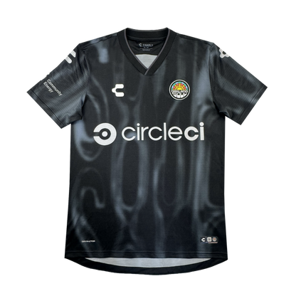 The 2026 OAKLAND SOUL SC SPIRIT JERSEY by Oakland Soul is a black, short-sleeve polyester soccer jersey with a subtle wavy pattern, white “circleci” sponsor on the front, logos on chest and sleeves, and a colorful round club crest.