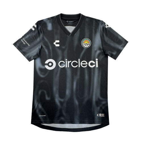 The 2026 OAKLAND SOUL SC SPIRIT JERSEY by Oakland Soul is a black, short-sleeve polyester soccer jersey with a subtle wavy pattern, white “circleci” sponsor on the front, logos on chest and sleeves, and a colorful round club crest.