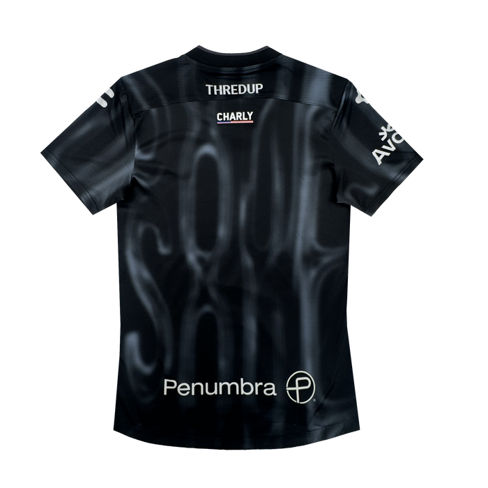 The 2026 OAKLAND SOUL SC SPIRIT JERSEY by Oakland Soul is a black polyester soccer jersey with subtle white smoky patterns, sponsor logos including THREDUP, CHARLY, Penumbra (with circular icon), and a partly visible AVC on the sleeve.