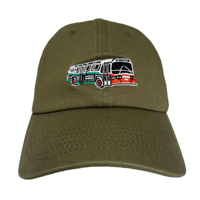 The Oaklandish AC Transit Dad Hat features an olive green, unstructured low-profile design with a retro bus embroidery inspired by classic Latin American buses and East Bay’s AC Transit, adding casual local flair.