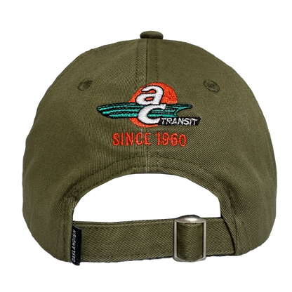 The Oaklandish AC Transit Dad Hat features a vintage-inspired green design with an embroidered "a TRANSIT SINCE 1960" logo, paying homage to classic AC Transit style.