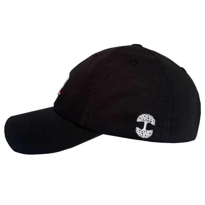 The Oaklandish AC Transit Dad Hat is a black, vintage-inspired cap with a curved brim, structured crown, ventilation eyelets, and a white embroidered logo resembling a stylized tree near the back. Shown from the side against a plain white background.