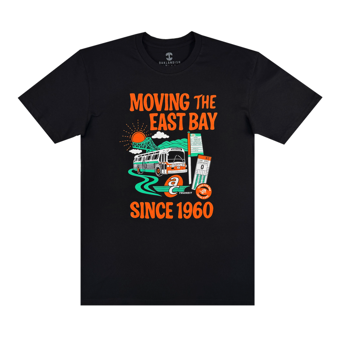 The Oaklandish AC Transit Moves The East Bay Tee is a black vintage shirt with colorful AC Transit bus art, green road, sun, street sign, ticket, and bold "MOVING THE EAST BAY SINCE 1960" text—a tribute to East Bay public transit.