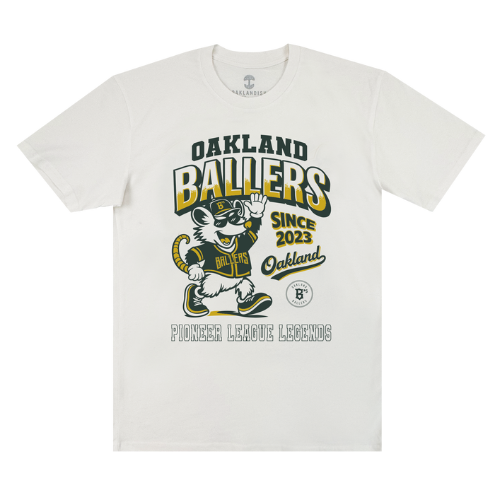 The Ballers Heritage Tee by Oakland Ballers features a cartoon mouse in an Oakland Ballers uniform, waving. The shirt displays the text: “OAKLAND BALLERS SINCE 2023 Oakland PIONEER LEAGUE LEGENDS.” Designed in yellow, green, and black, this tee celebrates the spirit of the Oakland baseball team.