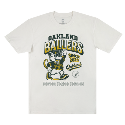 The Ballers Heritage Tee by Oakland Ballers features a cartoon mouse in an Oakland Ballers uniform, waving. The shirt displays the text: “OAKLAND BALLERS SINCE 2023 Oakland PIONEER LEAGUE LEGENDS.” Designed in yellow, green, and black, this tee celebrates the spirit of the Oakland baseball team.