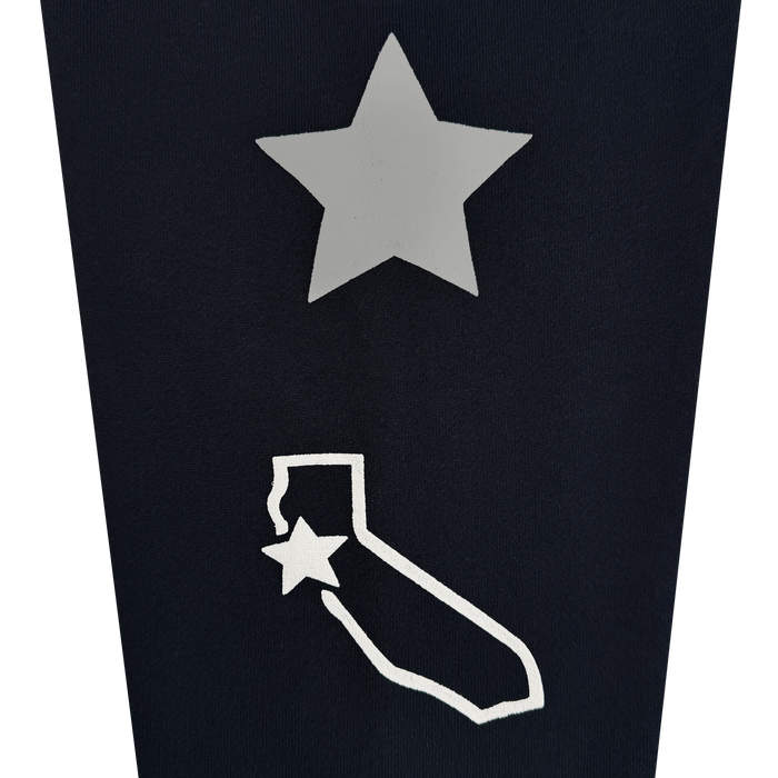 A silver star sits above a white outline of California on a black background, channeling bold Bay Area energy. Another white star accents the top left corner of the California outline, making the Bay Bridge Hoodie by DOC from Other a standout addition to any outerwear collection.