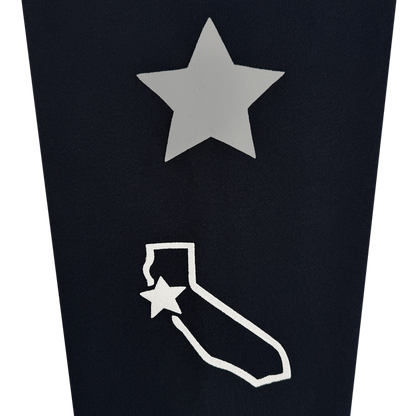 A silver star sits above a white outline of California on a black background, channeling bold Bay Area energy. Another white star accents the top left corner of the California outline, making the Bay Bridge Hoodie by DOC from Other a standout addition to any outerwear collection.
