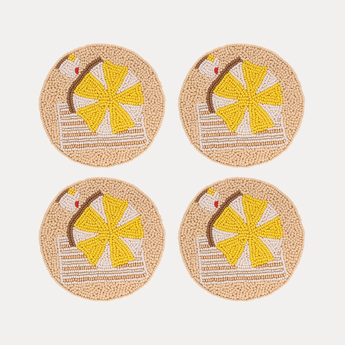 a group of coasters with a beach scene