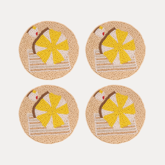 a group of coasters with a beach scene