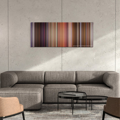 Bedazzled color palette canvas on a concrete wall above a gray sectional sofa