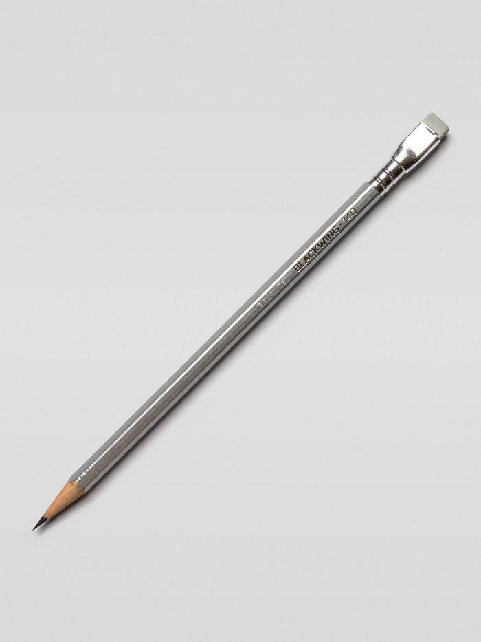 Single Blackwing 140 pencil placed diagonally on a light background, emphasizing the sleek, stainless steel-inspired barrel.