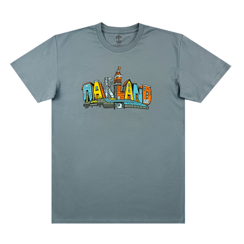 The Oaklandish Blockletters Tee is a gray shirt with a vibrant chest graphic spelling “OAKLAND,” each letter styled as a city landmark, including skyscrapers and the skyline.