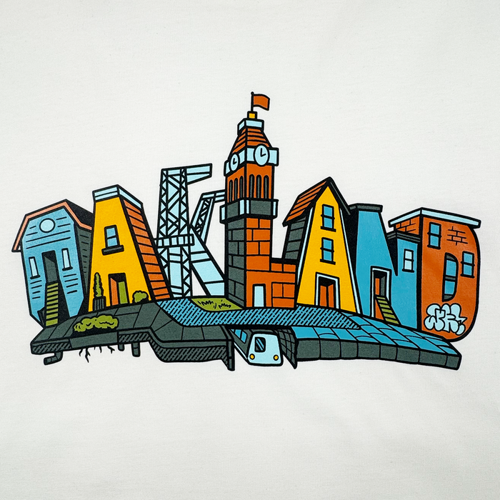 The Oaklandish Blockletters Tee features a colorful cityscape spelling "OAKLAND," with each letter as a landmark. A clock tower forms the "L," and a subway train, greenery, and graffiti capture the city's vibrant urban spirit.