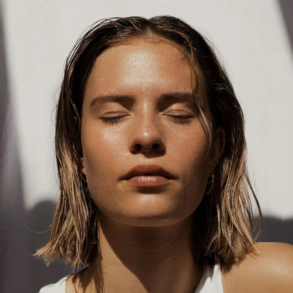 a woman with wet hair and eyes closed