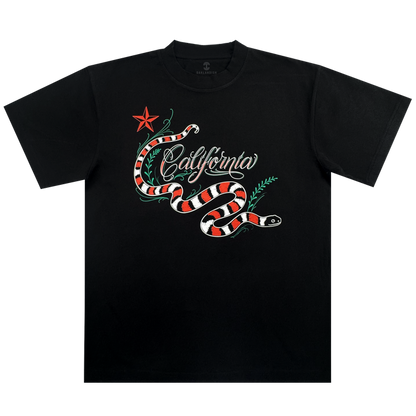 The Oaklandish CA King Tee is a men’s black t-shirt with a bold red, white, and black snake, green leaves, a red star, and “California” in white cursive across the chest. This classic fit heavyweight cotton tee ensures lasting comfort.