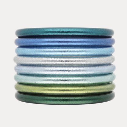 Confetti Stack vibrant cool-toned All Weather Bangle® collection in peacock blues and refreshing greens.