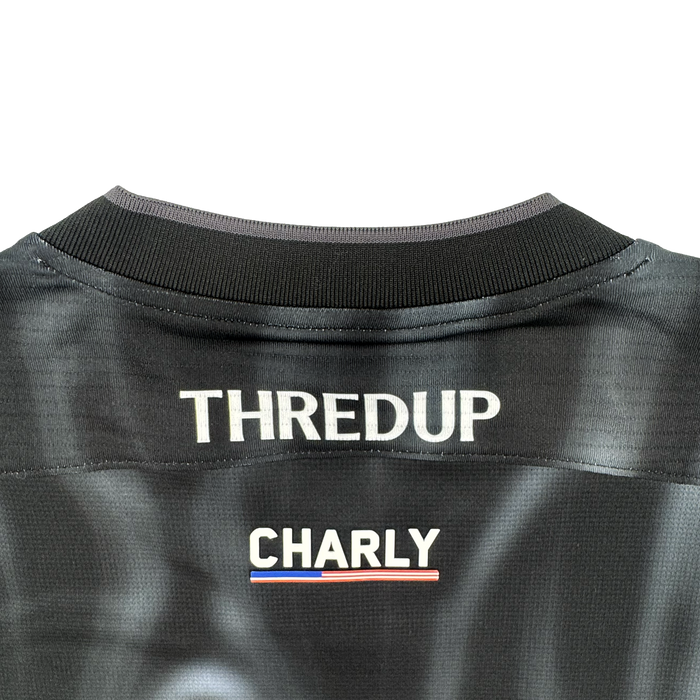 The image displays the upper back of a black Custom 2026 OAKLAND SOUL SC SPIRIT JERSEY by Oakland Soul. "THREDUP" appears in bold white at the top, above "CHARLY" and a small red, white, and blue stripe. The background is light gray.