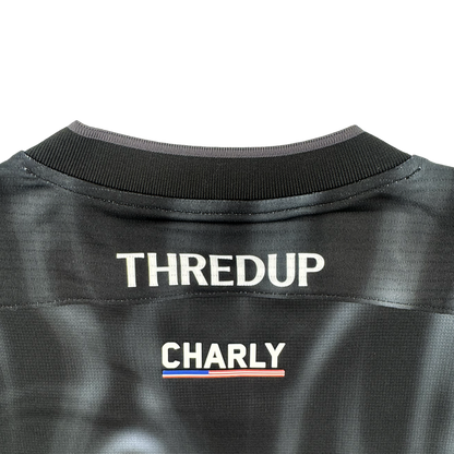 The image displays the upper back of a black Custom 2026 OAKLAND SOUL SC SPIRIT JERSEY by Oakland Soul. "THREDUP" appears in bold white at the top, above "CHARLY" and a small red, white, and blue stripe. The background is light gray.