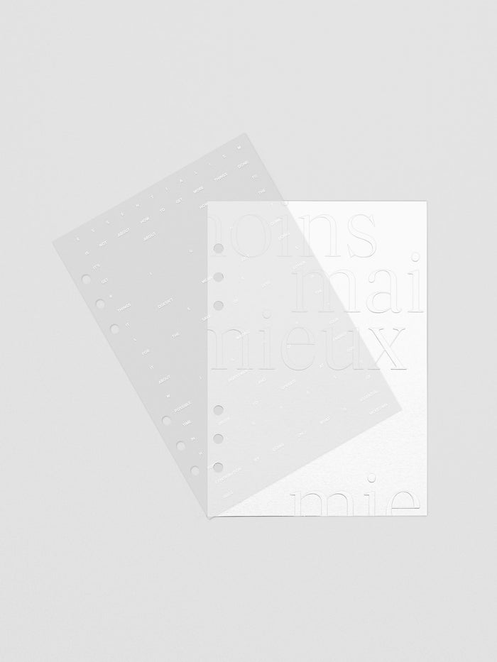 Essentialism Dashboard Duo reading "moins mai mieux" in size A5 shown offset to display a transparent and cardstock layer.