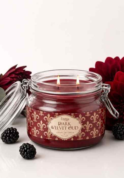 Eternia Dark Velvet Oud jar candle in clear glass with burgundy wax and metal handles