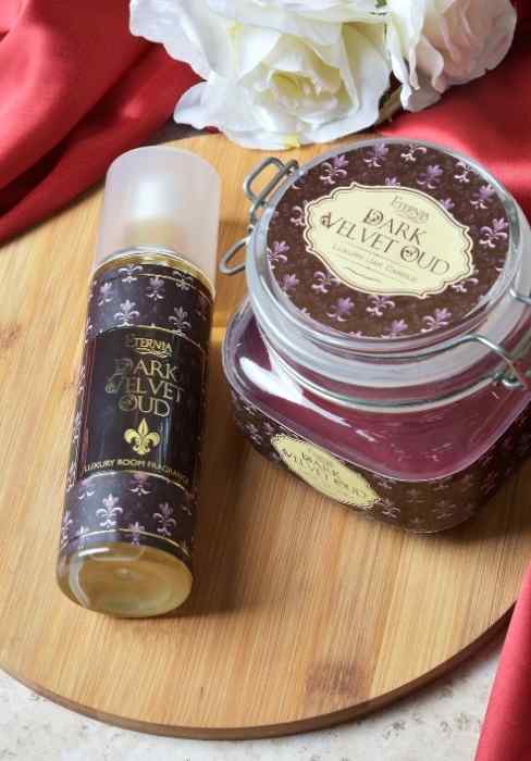 Eternia Dark Velvet Oud jar candle with matching dark label and burgundy wax in glass