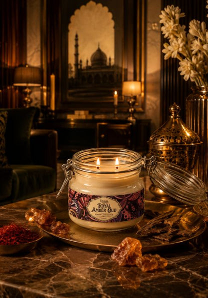 Royal Amber Oud amber jar candle with two lit wicks on an ornate tray