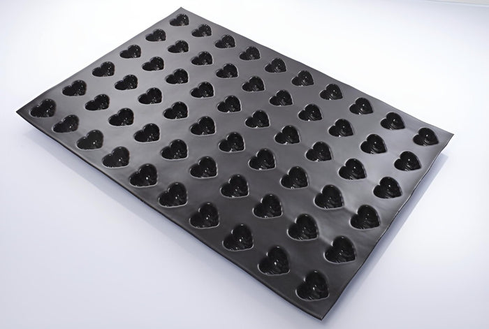 A black Flexipan fluted hearts mold with 60 cavities for baking or crafting.