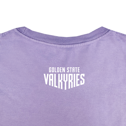 A close-up of the back of the GSV Golden State Valkyries Rec League Premium Tee in lavender organic cotton, featuring bold white "GOLDEN STATE VALKYRIES" text near the neckline, visible fabric texture, and a ribbed collar.