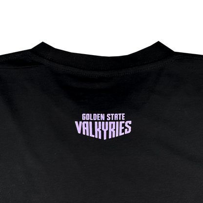 The image features the back of the GSV Golden State Valkyries Rec League Tee, an organic cotton shirt in black. Centered below the neckline, "GOLDEN STATE VALKYRIES" appears in bold pale purple blocky uppercase letters.