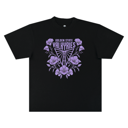 The GSV Poppies Tee by GSV is a classic fit t-shirt made from 100% cotton, showcasing “GOLDEN STATE VALKYRIES” above a triangular, stylized logo, all framed by lilac-hued flowers and leaves and centered on the chest.