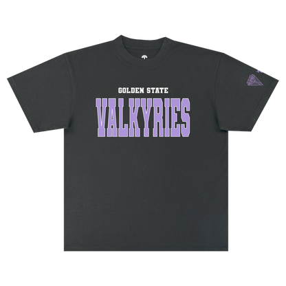 The GSV Varsity Tee by GSV is a classic fit, 100% cotton black t-shirt featuring “GOLDEN STATE” in white above bold purple “VALKYRIES” block letters across the chest. A small purple triangle logo appears on the left sleeve, standing out against the plain white background.