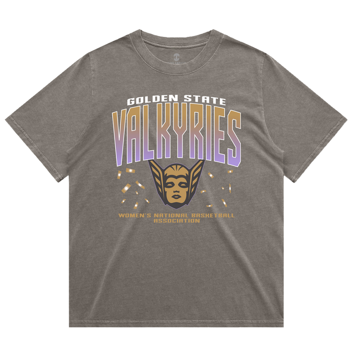 The GSV Women’s First Flight Tee by GSV features an oversized fit in gray, showcasing “Golden State Valkyries” in bold white and purple lettering, a striking gold valkyrie face with wings, and “Women’s National Basketball Association” in smaller gold text beneath. This heavy-weight tee offers both comfort and style for dedicated Golden State Valkyries fans.