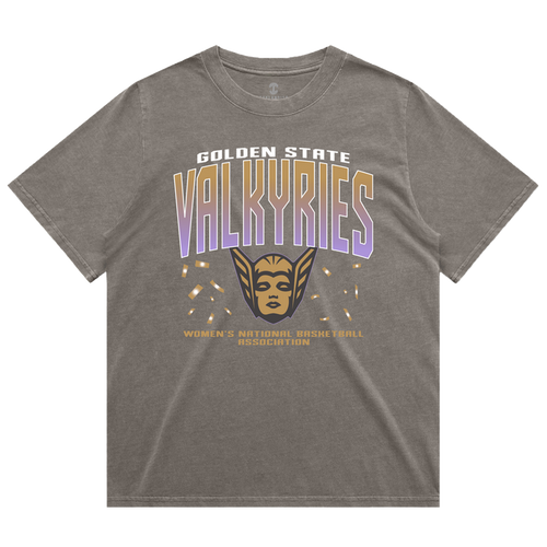 The GSV Women’s First Flight Tee by GSV features an oversized fit in gray, showcasing “Golden State Valkyries” in bold white and purple lettering, a striking gold valkyrie face with wings, and “Women’s National Basketball Association” in smaller gold text beneath. This heavy-weight tee offers both comfort and style for dedicated Golden State Valkyries fans.