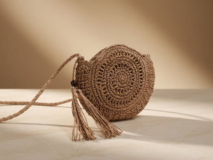 Handwoven round Raffia shell crossbody shoulder bag by Grace Beauty, featuring a hollow fashion design and compact style.