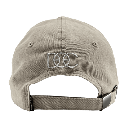 Back view of khaki Oakland Dad Hat designed by Dustin O. Canalin white embroidered DOC wordmark, adjustable strapback, and small Oaklandish wordmark tag.