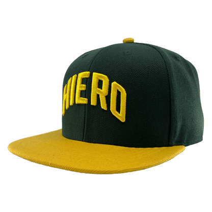 The green snapback cap with a yellow flat-billed visor and an embroidered HIERO wordmark on the crown.