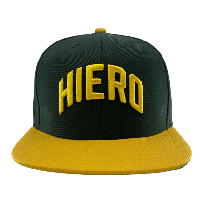 Front view green snapback cap with a yellow flat-billed visor and an embroidered HIERO wordmark on the crown.
