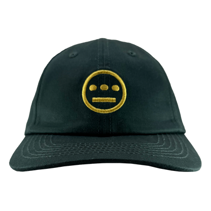 The Hiero Logo Dad Hat by Hieroglyphics is a black cap with a yellow embroidered face featuring two horizontal eyes and a mouth on the front. It includes a curved brim with stitched details and an adjustable strap back, set against a plain white background.