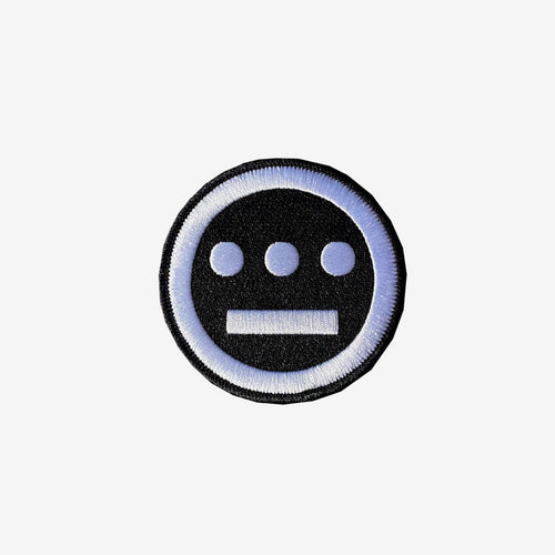 The Hiero Logo Patch by Hieroglyphics is a circular iron-on patch featuring intricate embroidery on a black background with a white embroidered border. The detailed interior design showcases three horizontally arranged white dots above a white horizontal line, resembling eyes and a mouth. It's the ideal accessory for adding unique flair to your collection.