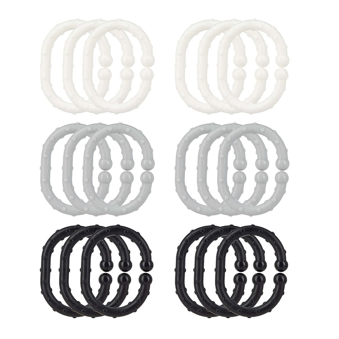 Eighteen Linkables Teething Toys in black, grey, and white shades, arranged in a grid. These textured rings are perfect stroller toy links and sensory toys for babies.