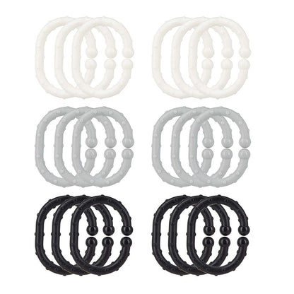 Eighteen Linkables Teething Toys in black, grey, and white shades, arranged in a grid. These textured rings are perfect stroller toy links and sensory toys for babies.