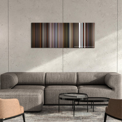 Little Nicky color palette canvas on a concrete wall above a gray sectional sofa